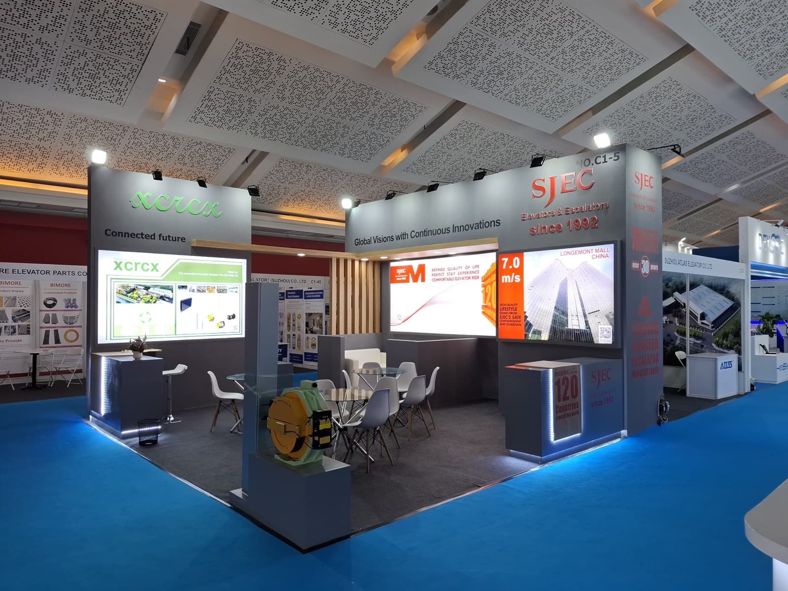 The SJEC stand C1-5 at Indonesia Lift Expo 2025, its fascia reading Global Visions with Continuous Innovations, with a traction machine displayed in front