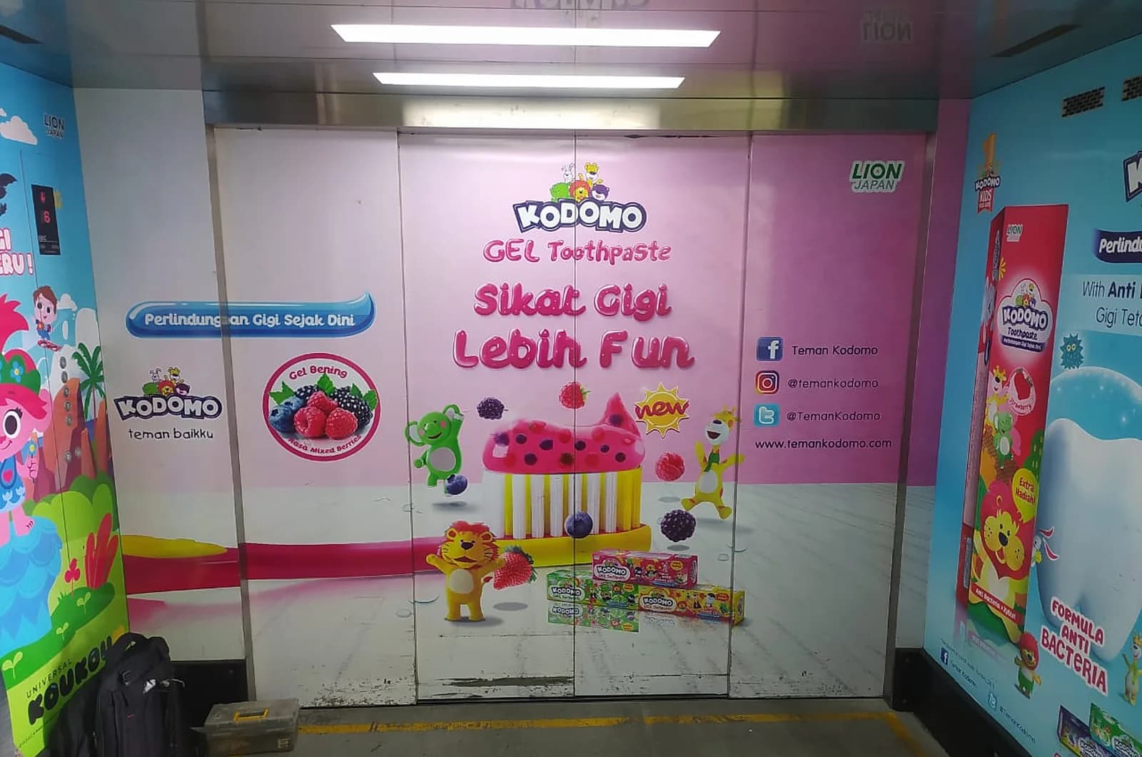 Cargo lift landing doors at the Lion Wings factory, wrapped in Kodomo product graphics