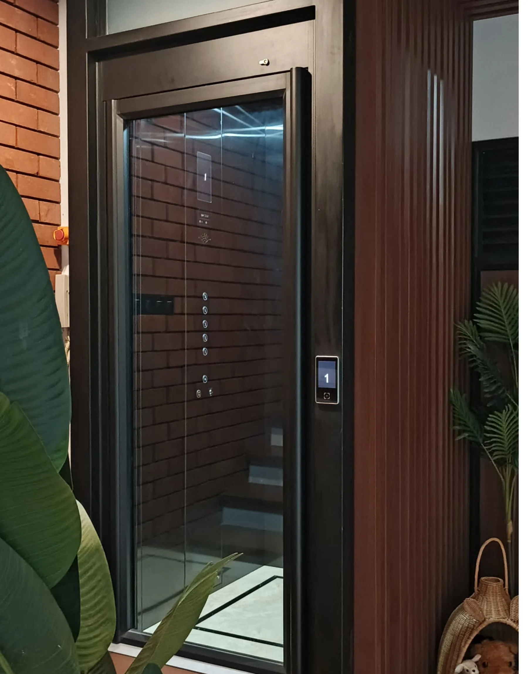 Tenka V300 home lift with a glazed door and touch panel at Nivara Kemang Townhouse, Jakarta