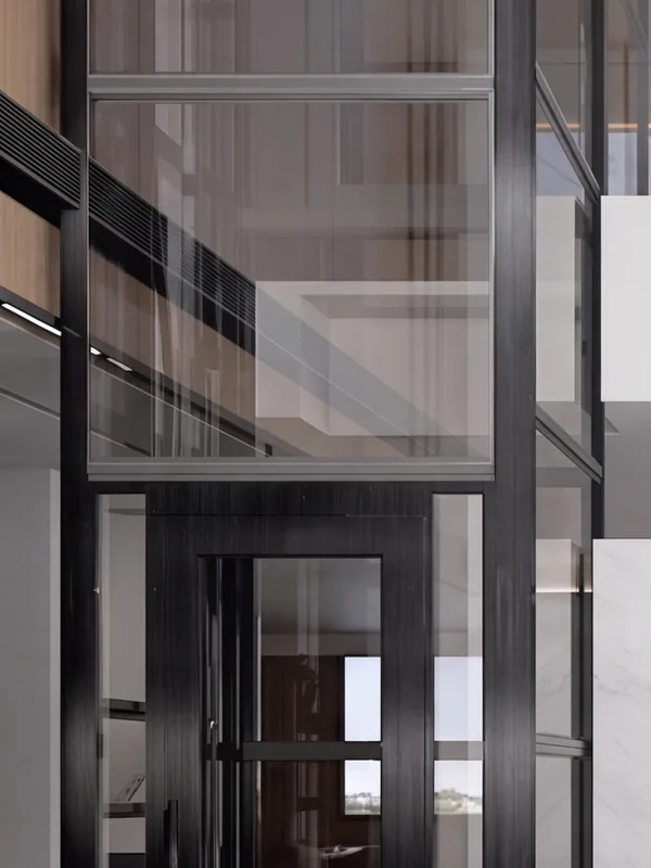 Lift rumah V300 dalam shaft kaca berangka hitam yang naik melalui ruang keluarga berlangit-langit ganda