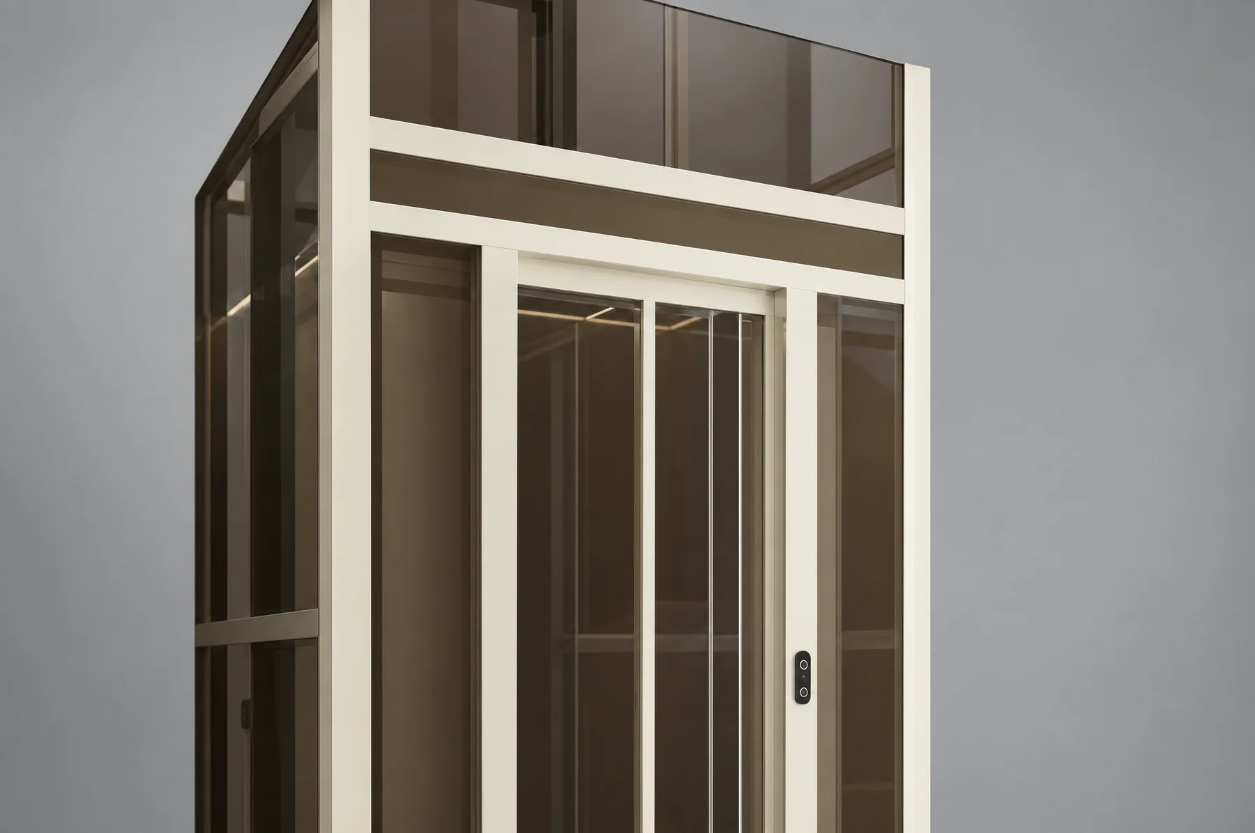 Studio close-up of the Tenkai Kaze: a cream aluminium shaft frame with bronze-tinted glass, the sliding car door behind it, and the landing call panel set into the frame post