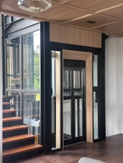 Glazed home lift beside a timber staircase at a villa in Dago, Bandung